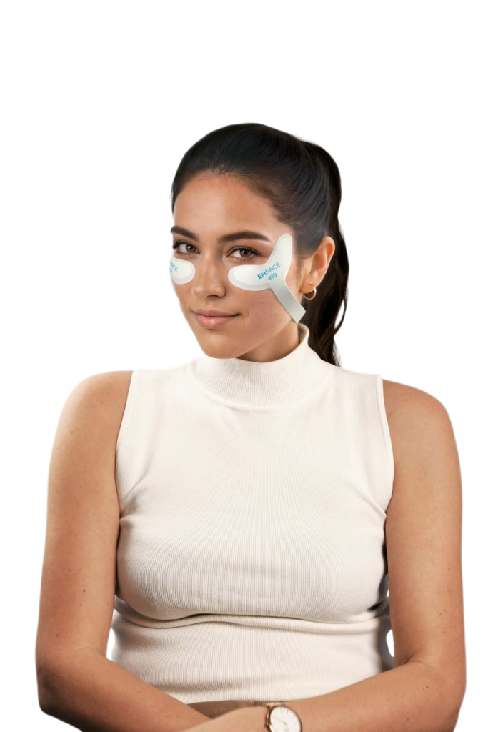 Woman wearing EMFACE under-eye patches during a skincare treatment.